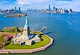 Aerial view of the Statue of Liberty, Ellis Island, and Lower Manhattan Skyline from New York Harbor near Liberty State Park in New Jersey.