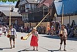 People dressed in traditional German clothes carry large alpenhorns during the Maifest celebration in Leavenworth, Washington. Image credit Gregory Johnston via Shutterstock