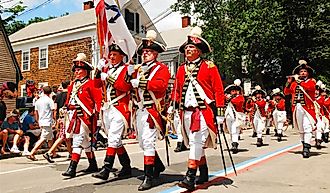 Adults dressed in British red coats from the American Revolution in Bristol, Rhode Island. Image credit James Kirkikis via Shutterstock