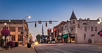 Scarce traffic on Main Street in downtown Woodford county's Versailles, Kentucky during sunrise.