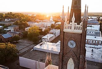 Sunset light shines on a historic church and landscape of downtown Natchez, Mississippi. Image credit Matt Gush via Shutterstock