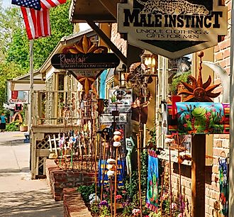 A Boutique Store displays its sales along the sidewalk to entice customers in the charming small town of Nashville, Indiana. Editorial credit: James Kirkikis / Shutterstock.com