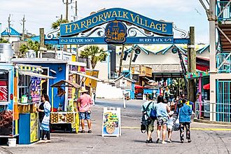 Destin, USA - April 24, 2018: Sign for Harborwalk Village in Emerald Grande Coast in Florida Panhandle with people walking and shopping,