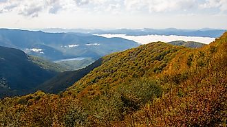 Clouds hanging over North Carolina's Blue Ridge Mountains, part of the Appalachians, near Asheville and Charlotte, with vibrant fall foliage and close proximity to the borders with South Carolina, Georgia, Tennessee, and Virginia.