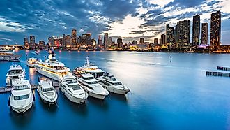 Miami, Florida marina and skyline at dusk on a cloudy evening.