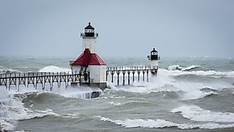 Lake Michigan Lighthouse in St Joe gets pounded during a massive wind storm and waves flow over the entire pier.