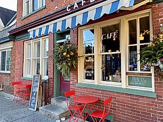 Cafe with a striped awning and red tables and chairs in downtown Stroudsburg, Pennsylvania. Editorial credit: Here Now / Shutterstock.com