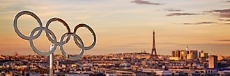 The Olympic Rings with the Eiffel Tower in the background. Image by Delpixel via Shutterstock.com