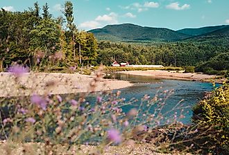 Farm along the water in Keene, New York. Image credit Chelsea Mealo via Shutterstock