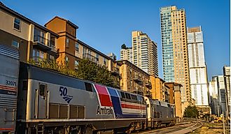 An Amtrak Texas Eagle train stops in the Austin Texas depot with the skyline in the background. Editorial credit: Ian Mason / Shutterstock.com