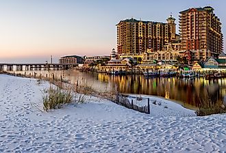 Panoramic sunset photo of HarborWalk Village in Destin, FL. Image credit speedrealm via Adobe Stock.