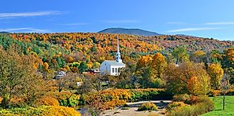 Stowe panorama in Autumn with colorful foliage and community church in Vermont. 