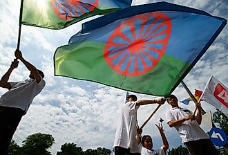 Roma activists wave the Romanian flag and protest in front of the Russian embassy. Image credit LCV via Shutterstock