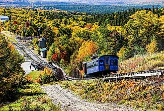 Cog railway steam train is returning from Mt. Washington tour with tourists, New Hampshire. Image credit Miro Vrlik Photography via Shutterstock