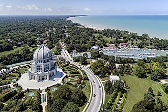 Aerial view of a temple, harbor, and shoreline in Wilmette, Illinois, showcasing the picturesque landscape along Lake Michigan.