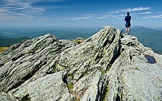 Hiker on Camels Hump in Vermont, which is part of the Long Trail.