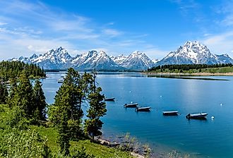 Spring view of a quiet bay of Jackson Lake, with Teton Range rising in the background, Grand Teton National Park, Wyoming.