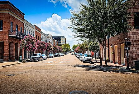 Cars parked along city street in downtown Natchez on a summer day. Image credit VioletSkyAdventures via Shutterstock.