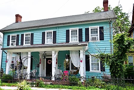 A beautifully restored colonial-style home, painted blue with black shutters, in the historical district of downtown Laurel, Delaware. Editorial credit: Dee Dalasio / Shutterstock.com