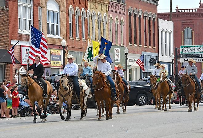 Horseback riders in a parade in Council Grove, Kansas. Image credit Mark Reinstein via Shutterstock