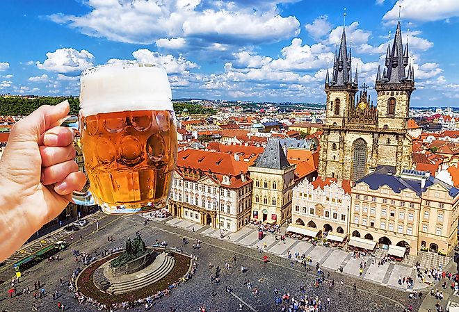 Mug of beer on the background of the Old Town Square in Prague, Czechia.