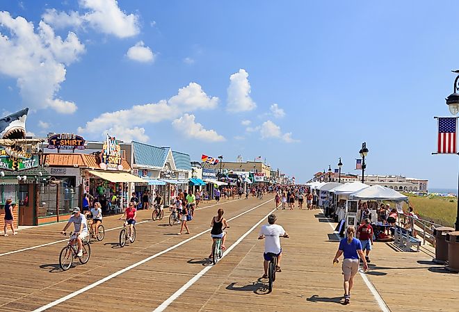 People walking and biking along the boardwalk in Ocean City, New Jersey. Image credit Vlad G via Shutterstock