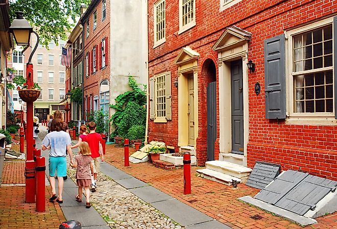 A family strolls down Elfreth's Alley, Philadelphia, the oldest street in continuous use in the United States.