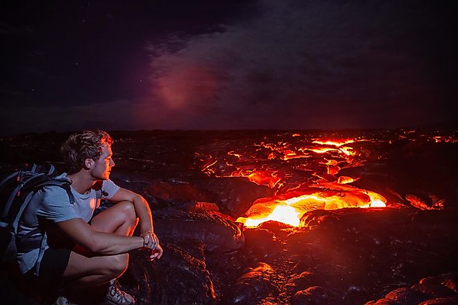 Tourist admiring the spectacular view of a volcano at the Hawaii Volcanoes National Park.