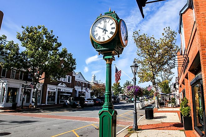 Downtown in nice day with clock, store fronts, restaurant and blue sky on Elm Street