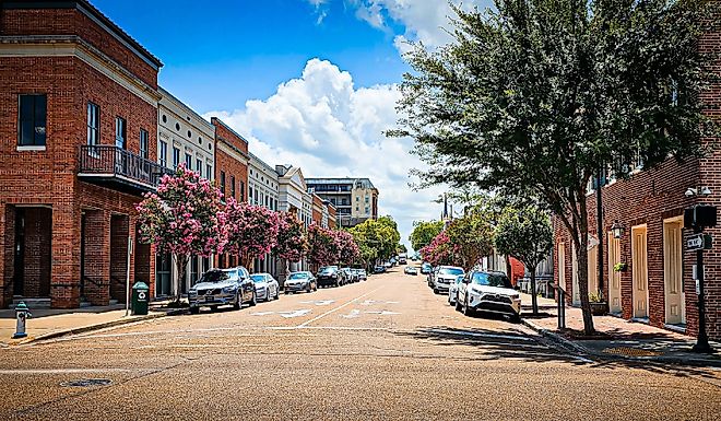 Cars parked along city street in downtown Natchez on a summer day. Editorial credit: VioletSkyAdventures / Shutterstock.com