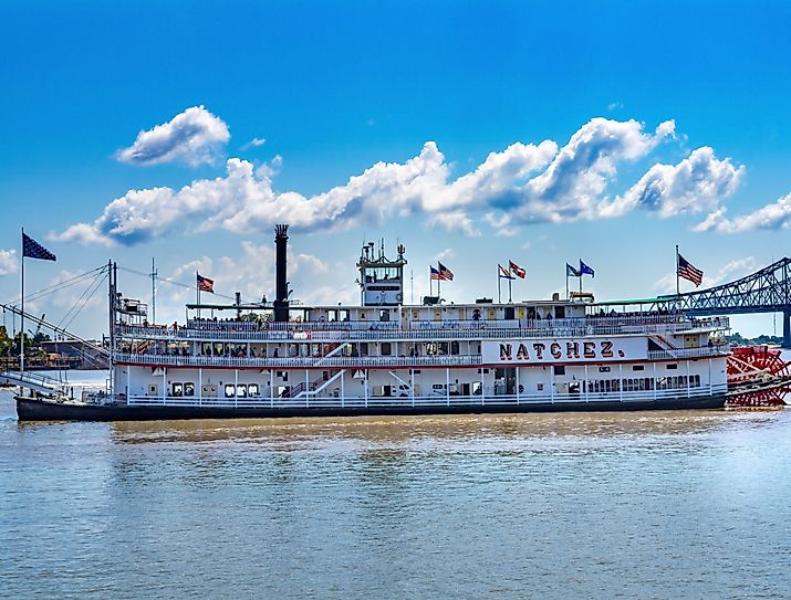 Tourists Natchez Steamboat Riverboat Flags Wharf Mississippi River New Orleans Louisiana. Image credit: Bill Perry via shutterstock