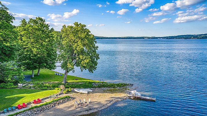 Keuka Lake surrounded by green trees during the summertime.