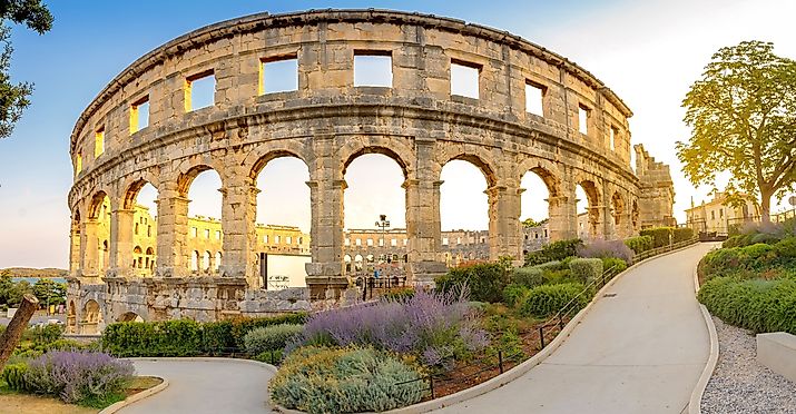 Ancient Roman Amphitheater in Pula at dawn, Croatia. Image credit Saga Photo and Video via Shutterstock