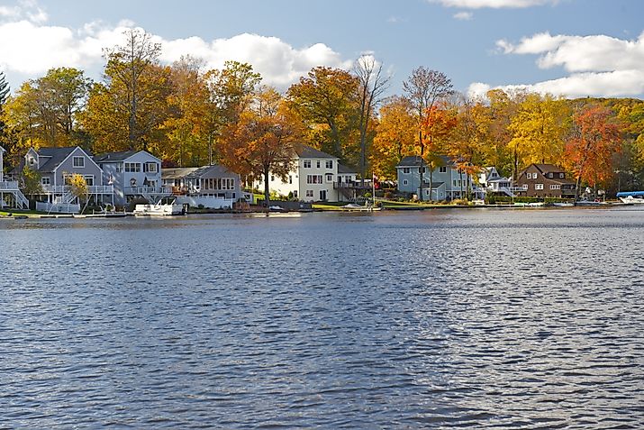 Waterfront homes and fall foliage in the town of Winsted in Winchester, Connecticut.