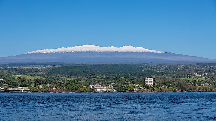 Picture of Hilo, Hawaii, on a sunny day with snow-capped Mauna Kea in the background.