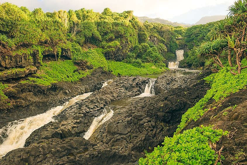 Beautiful waterfall cascading between rocks surrounded by lush greenery in Haleakala National Park, Hawaii