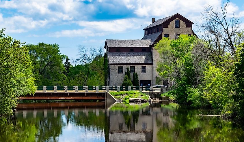 A brown stone mill and bridge over the Milwaukee River in Cedarburg, Wisconsin. 