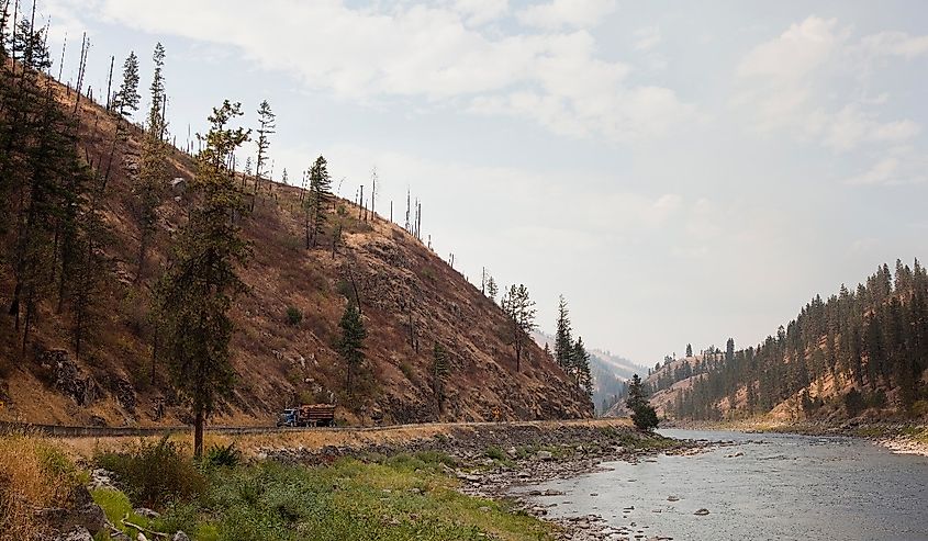 Clearwater river view west of Kamiah with tree-covered mountains on either side