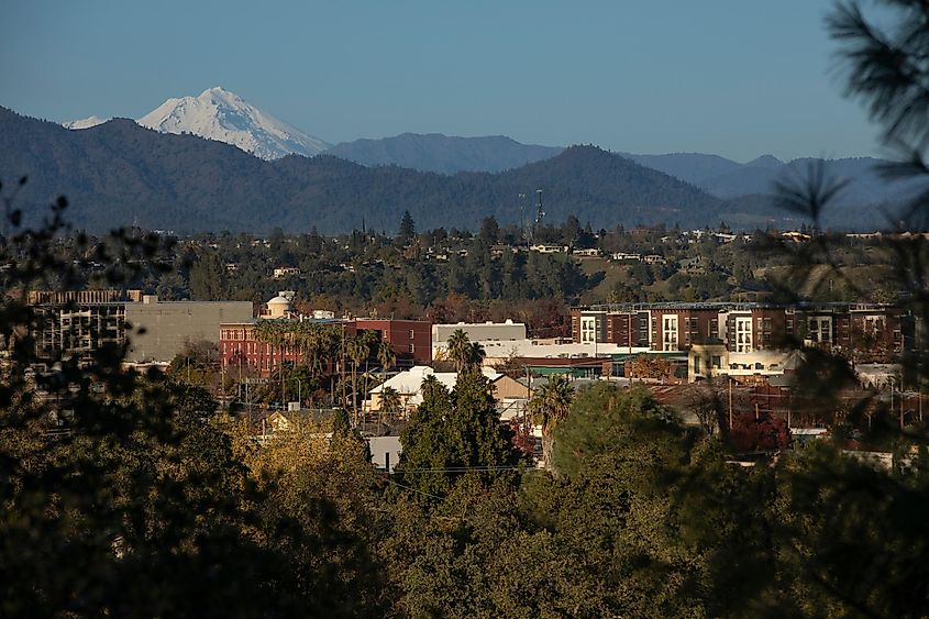 Afternoon snow covered view of the peak of Mount Shasta and the downtown skyline of Redding, California