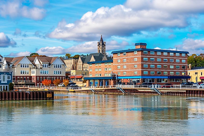 A scenic view of Port Washington, Wisconsin, highlighting the town's historic lighthouse, picturesque marina, and charming streets along the Lake Michigan shoreline.