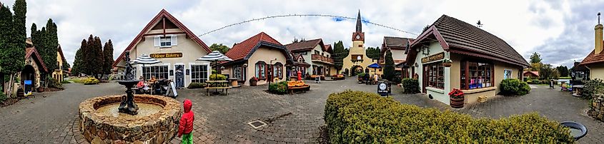 Grindelwald, a Swiss-inspired town in Tasmania, Australia, with distinctive chalet-style buildings set against lush greenery and rolling hills, offering a peaceful, picturesque atmosphere.