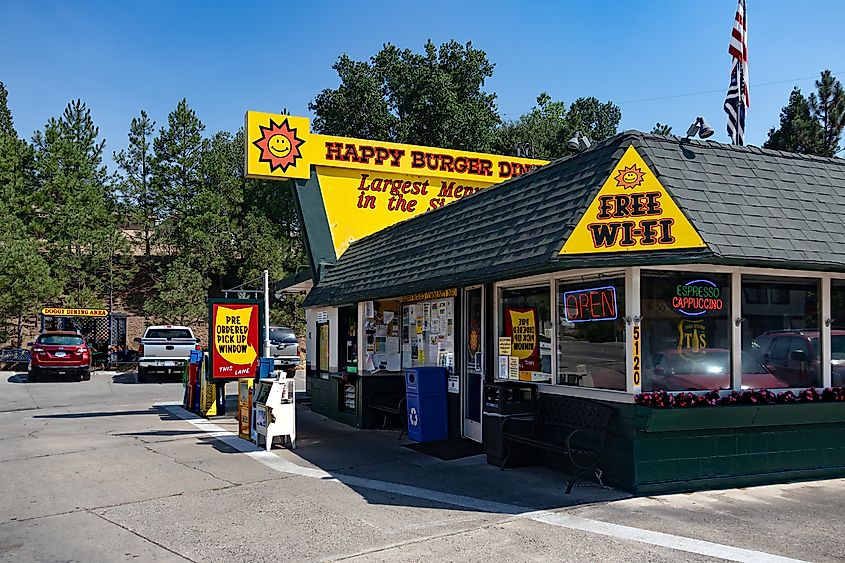 Happy Burger Diner in Mariposa, California, photographed from the corner on a bright blue day.