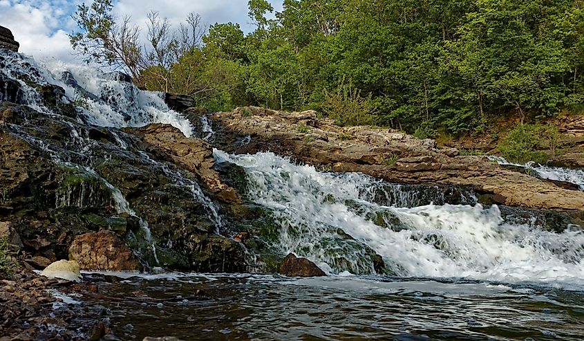 Water rushes over the Lake MacBride Waterfall