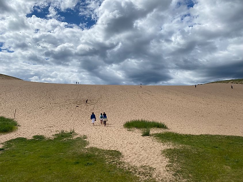 A small group of women make their way up a massive sand dune known as "The Dune Climb" in Michigan's Sleeping Bear Dunes National Lakeshore. 