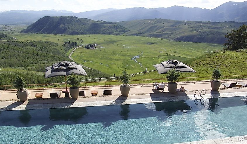 Upscale resort and spa has a pool terrace overlooking the valley and mountains in Wyoming