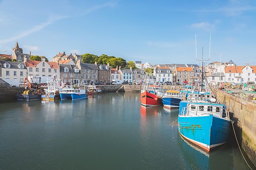 Colourful fishing boats moored at the harbour in the scenic East Neuk seaside village of Pittenweem, Fife, Scotland