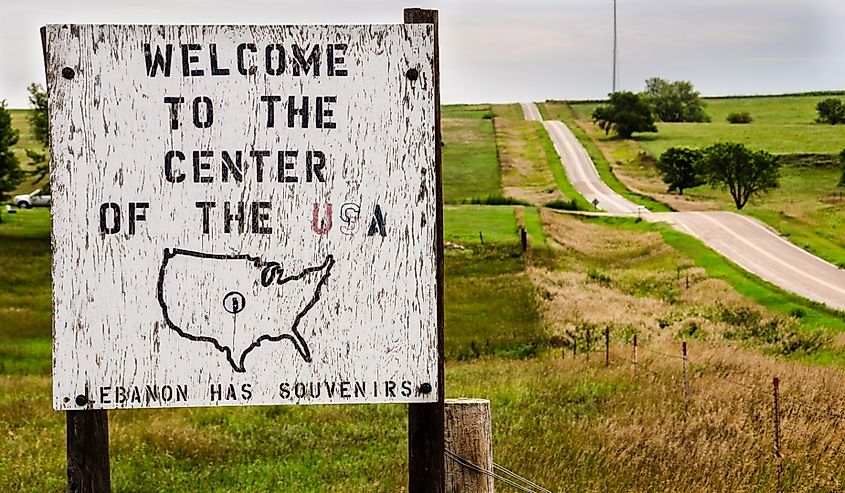 Wooden sign welcoming visitors to the geographical center of the continental United States near Lebanon, Kansas.