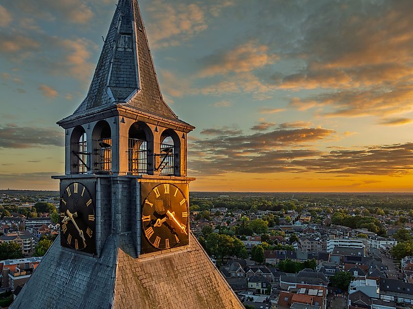 aerial view of the clock tower at sunset of the St Plechelmus basilica in Oldenzaal, the Netherlands