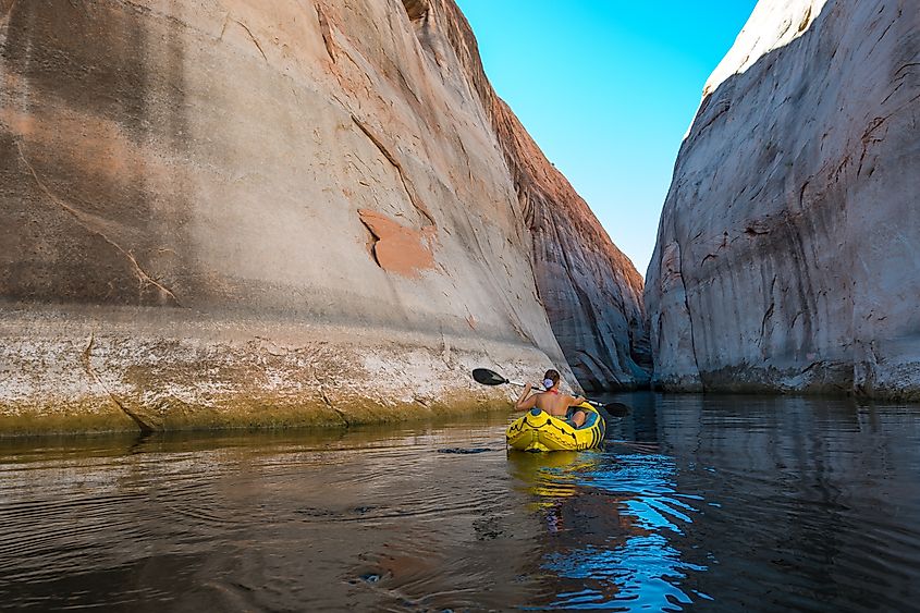 A kayaker paddles through Lost Eden Canyon.