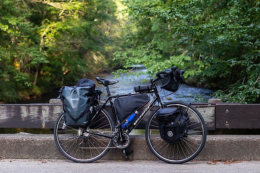 Fully Equipped Touring bike sitting next to a river in Brevard, North Carolina. Editorial credit: Luis Raul Torres / Shutterstock.com